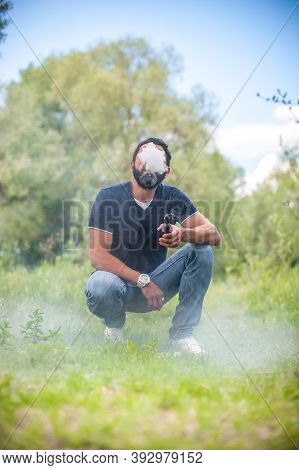 Handsome Vape Man Releases A Cloud Of Steam. Alternative To Smoking.