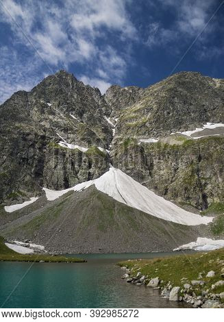 View Of The Imereti Lake And Mountains. Blue Lake Surrounded By Mountains And Glaciers.