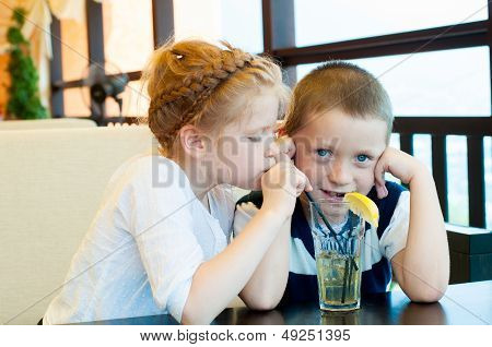 boy and girl drinking a drink with ice
