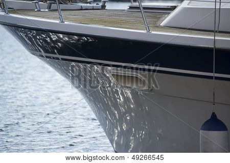 Hull Of Yacht Sailboat With Sea Reflections