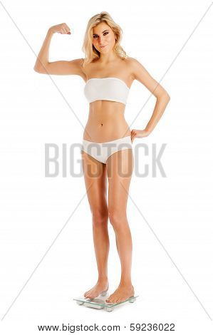 Muscle Woman Standing On Bathroom Scales.