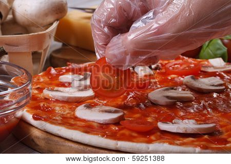 Hand Chef Puts On A Pizza Base Cherry Tomatoes. Macro.