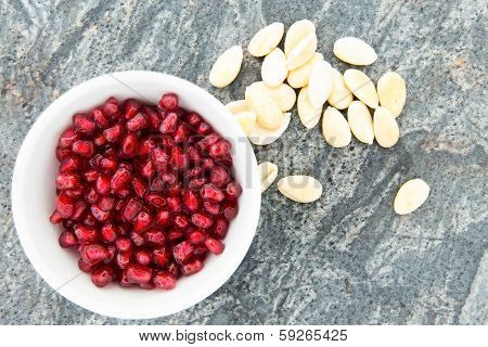 Seeds Of Fresh Pomegranate, Next To Peeled Almonds