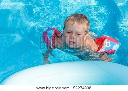 Boy Swims In The Pool