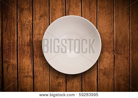 Colorful empty shiny plate on grungy background table 