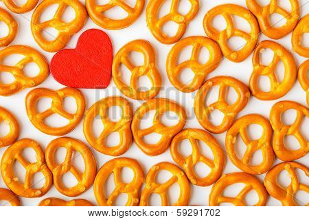 Valentine's Day Background Pretzels Pattern And Red Heart.