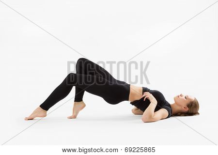 Sexy Girl In A Black Suit Lying On The Floor, Isolated On A White Batskground