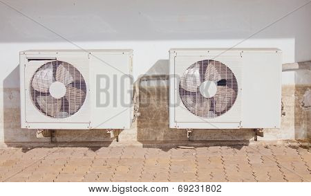 Air Condition Condensers Outside The Building With Dirty Wall.