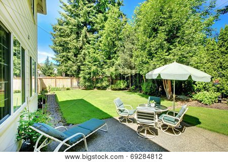 Suny Green Backyard With Yellow Hosue.