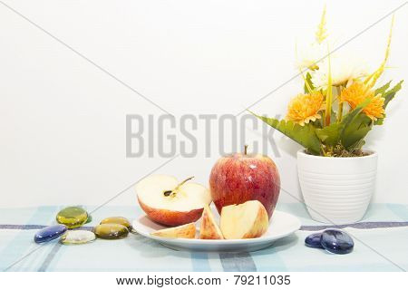 Pieces Of Apples On White Plate With Flowerpot