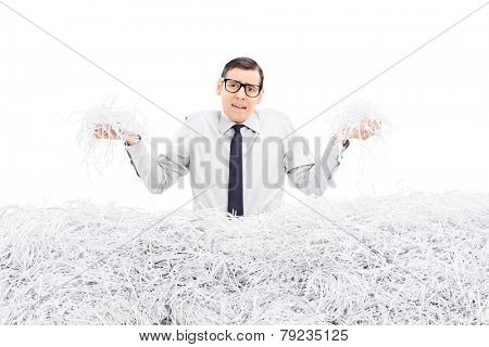 Powerless employee holding bunch of shredded paper isolated on white background