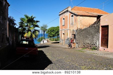 Woman Stands With Bicycle By Door