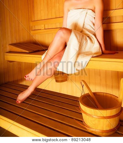 Woman Sitting Relaxed In Wooden Sauna