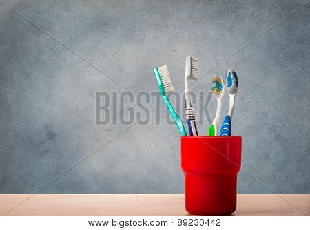 Toothbrushes On Blue Grunge Background