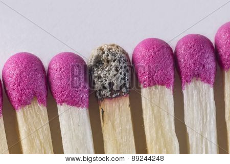 One burned match in a row