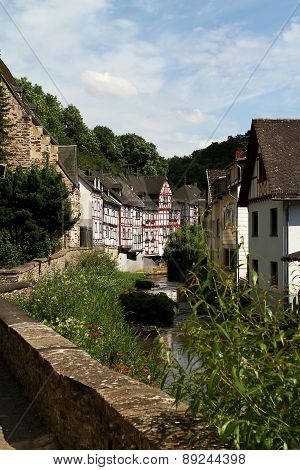 Creek lined with historic houses in the medieval village Monreal Germany