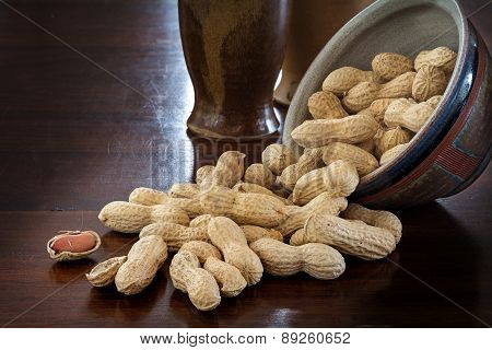 Peanuts In Shells And Rustic Ceramic Tableware On A Dark Table