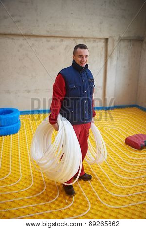 group of workera installing underfloor heating and colling in modern home