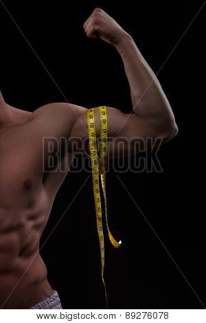 muscular hand with measurment tape