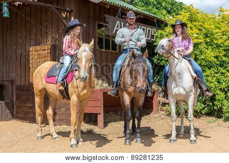 cowboy family of three on horses