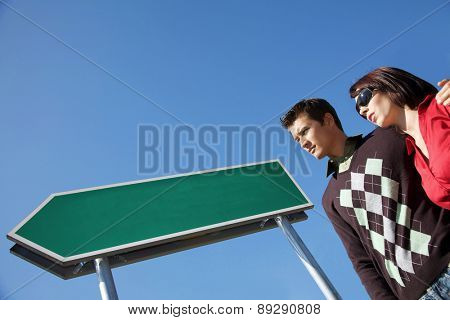 Low angle view of young couple with arm around