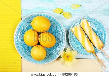 Lemons and ice cream on plates on table top view