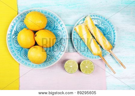 Lemons and ice cream on plates on table top view