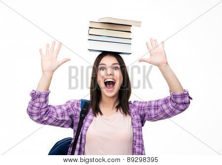 Laughing young wowan with books on head over white background. Looking at camera
