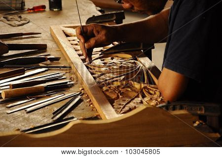 Skilled craftsman doing wood carving using traditional method