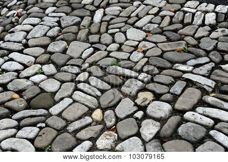 a natural stone road is laid out next to each other