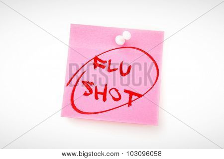flu shots against pink adhesive note with pushpin