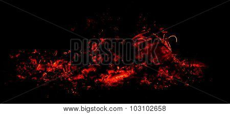 panorama the dying fire and hot red sparks on a black background