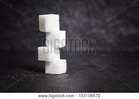 Cloose Up White Sugar Cubes On Black Stone Plate Background
