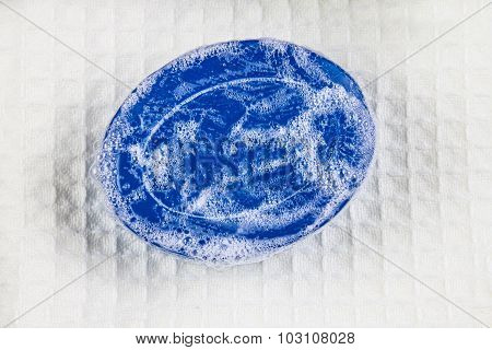 Natural Blue Soap Bar And Bubble Foam On  Bath Towel Background