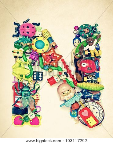 the letter    N  made from small toys