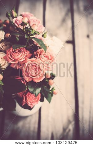 Bouquet of roses in vintage coffee pot