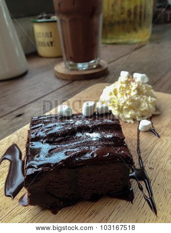 Fresh Homemade Chocolate Brownie against wooden background