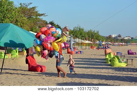 Young Vendor Of Animal Shaped Balloons At Legian Beach