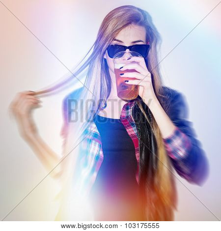 Cool trendy teenage girl drinking beer