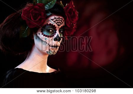 Woman in Halloween makeup - mexican Santa Muerte mask.