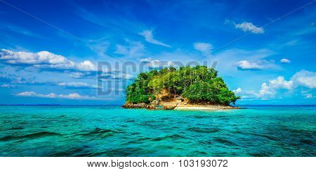 Panorama of tropical island and long-tail boat in sea. Thailand