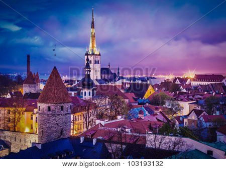 Vintage retro effect filtered hipster style image of Tallinn Medieval Old Town illuminated in evening twilight, with dramatic sky Estonia