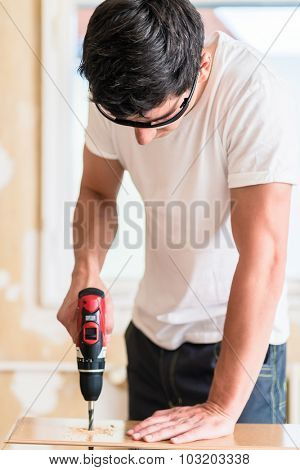 Craftsman or DIY man working with power drill
