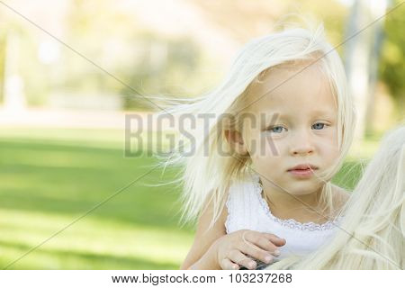 Melancholy Portrait of Cute Little Girl Outside in Park.