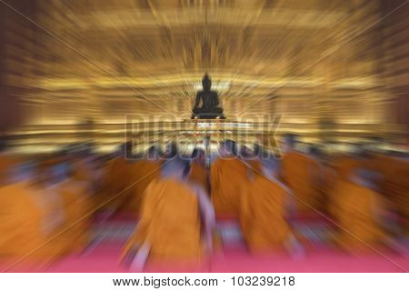 Blurred Zoom Of Thai Monk Worship In Temple