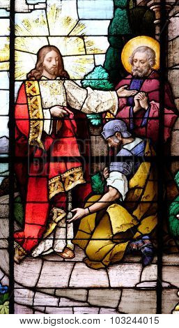 ZAGREB, CROATIA - MAY 28: Jesus and the centurion. Lord, I am not worthy to have you come under my roof..., stained glass in the Basilica of the Sacred Heart of Jesus in Zagreb, Croatia on May 28,2015