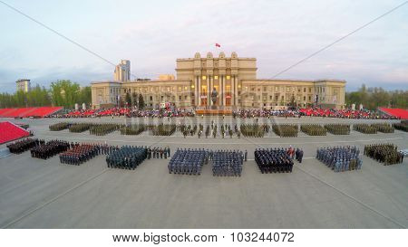 SAMARA - MAY 06, 2015: Formations of soldiers stand on square during rehearsal of parade at spring evening. Aerial view video frame