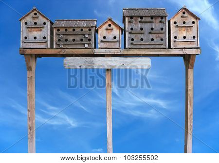Old Wooden Starling Nesting Boxes Bird House Over Blue Sky
