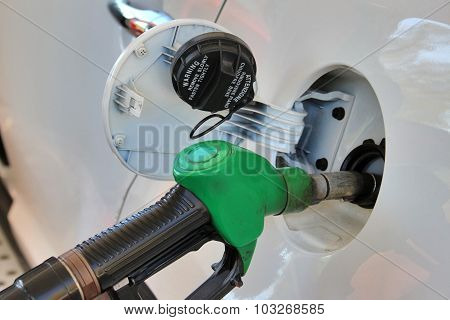Opened Tank And Gun Of Gas Station. Fuelling Gasoline In Car