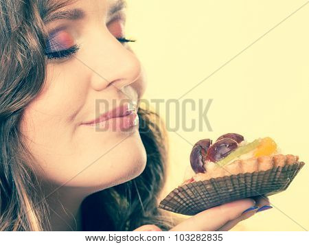 Woman Closed Eyes Holds Cake In Hand